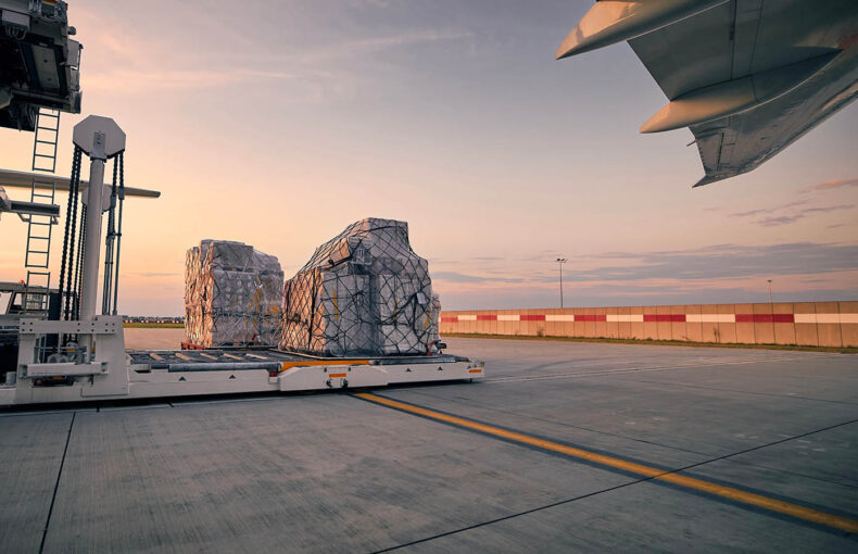 Loading of cargo containers onto airplane at airport
