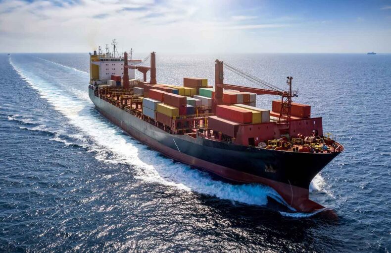 Aerial view of a loaded container cargo vessel over blue sea