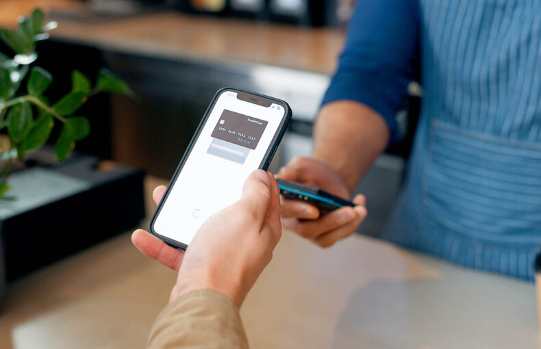 Person making mobile phone payment in a store