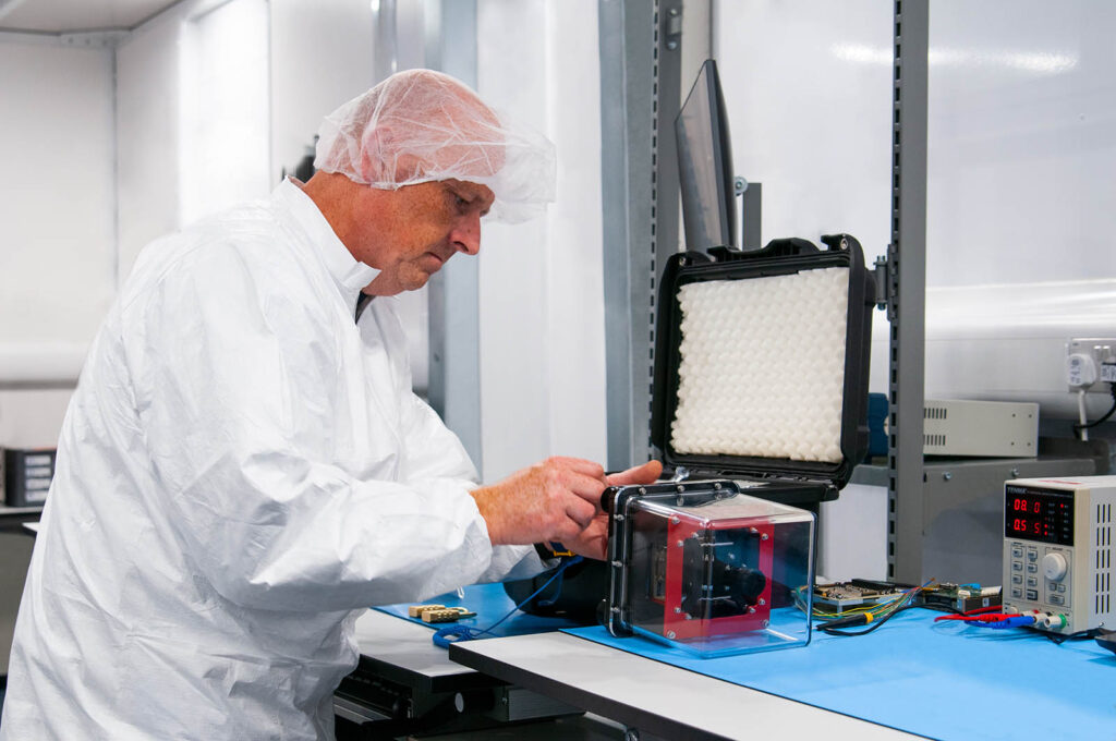 Satellite engineer working on a satellite payload